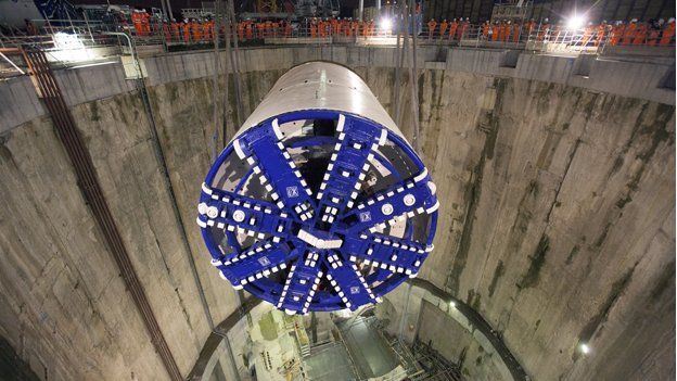 A tunnel-boring machine is lowered through a shaft on the London Crossrail site