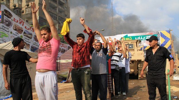 Egyptian security forces detain protesters as they clear a sit-in by supporters of ousted President Mohammed Morsi in the eastern Nasr City district of Cairo, Egypt, Aug 14, 2013
