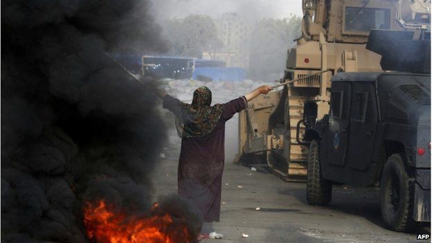 An Egyptian woman tries to stop a military bulldozer, 14 August