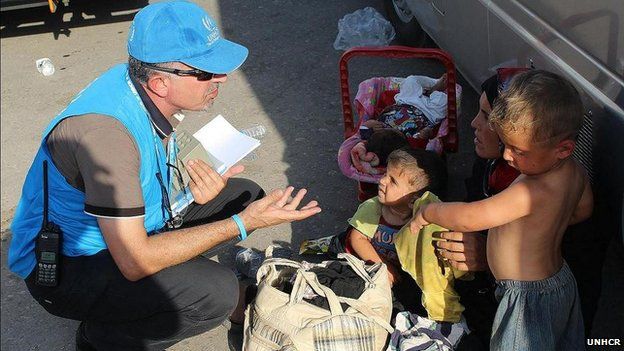 UNHCR official speaks to family of refugees
