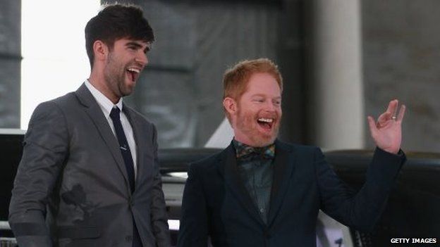 Modern Family actor Jesse Tyler Ferguson (R) and his husband Justin Mikita arrive for the reception at the Air New Zealand hanger on August 19, 2013 in Auckland, New Zealand.