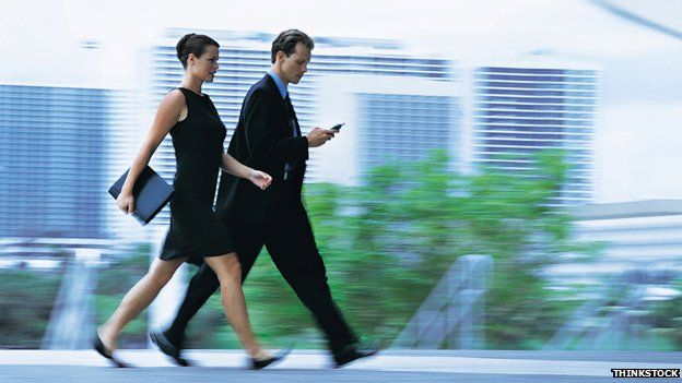 A businessman and businesswoman walking