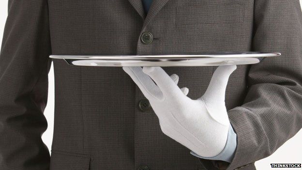 Butler holding tray (stock picture)