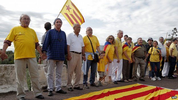 Catalan singer Lluis Llach (second left) helps to create a 400km human chain