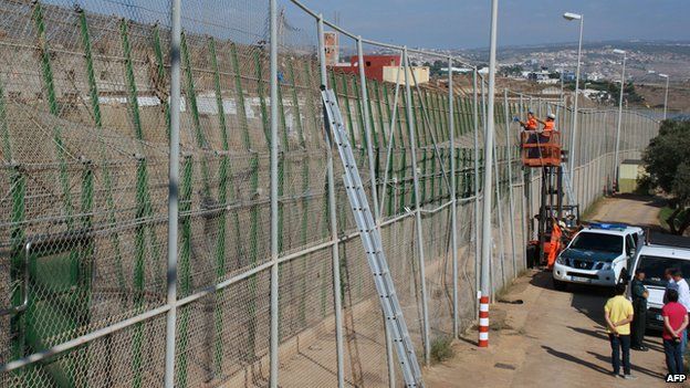 A handout picture taken and released on 17 September, 2013 by the Melilla's regional government shows employees repairing a border fence after immigrants tore it down to break from Morocco into Spain.