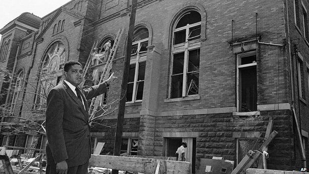 Rev John Cross points to the damage at the 16th Street Baptist Church in Birmingham, Alabama, a few days after the bombing