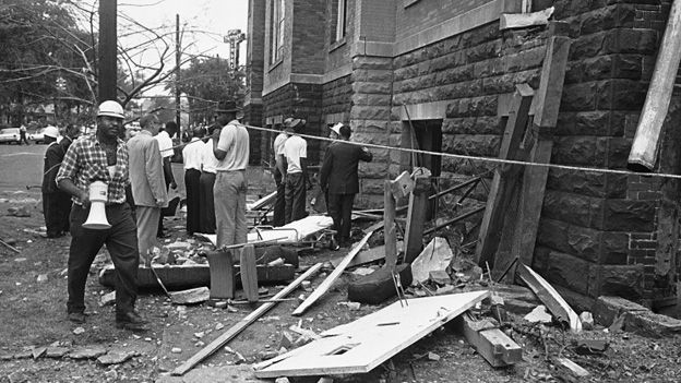 Investigators work outside the church in the aftermath to the bombing