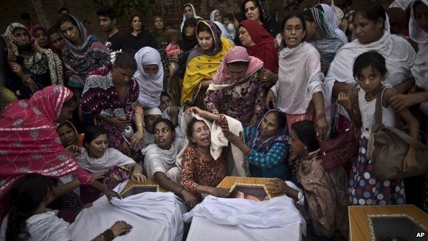 Sunday, Sept. 22, 2013: Peshawar, Pakistan_Pakistani women grieve over the coffins of their relatives, who were killed in a suicide attack on a church.