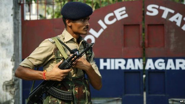 An Indian paramilitary soldier stands guard outside the site of an attack, at a police station in Hiranagar,