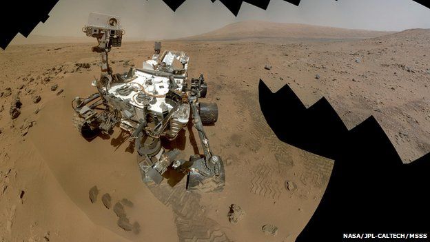 mars rover scooping dirt