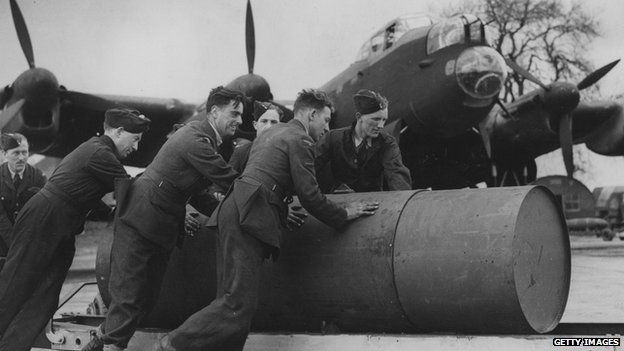 A ground crew move a 4,000 pound blast bomb into position for loading onto a Lancaster bomber, 18 October 1943