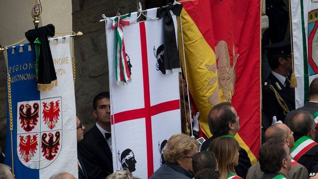 Black ribbons tied to flags in Assisi during Pope's visit on 4 October 2013