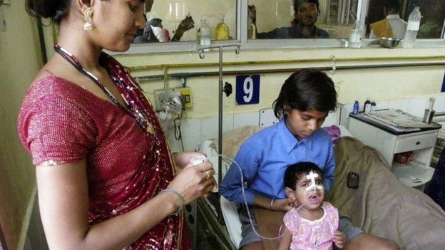 In this April 2, 2013 photo, a young Indian child, in a pink shirt, undergoes treatment for encephalitis at a hospital in Gorakhpur in Uttar Pradesh state, India