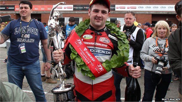 The celebrations begin for Honda Fireblade rider Michael Dunlop after his victory in the six-lap Superbike event