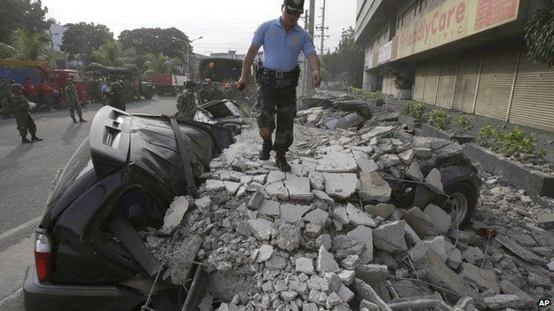 A police officer surveys the damage following a 7.2-magnitude earthquake that hit Cebu city