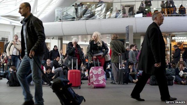 Passengers wait on concourse at King's Cross station after train services were cancelled
