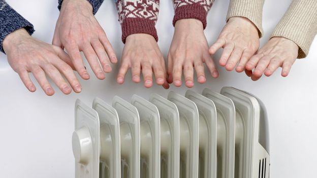 Hands around radiator