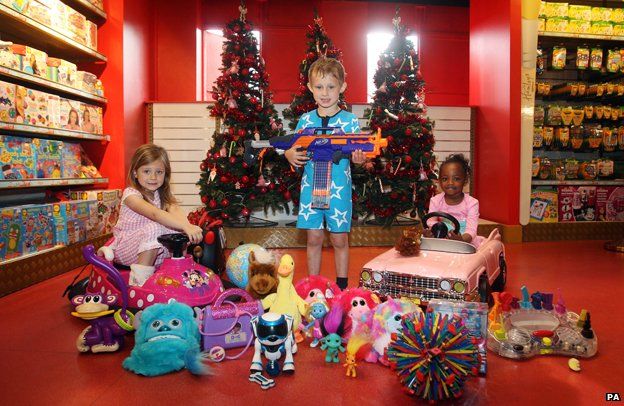 Children with array of toys in shop