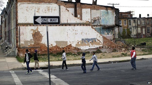 Children playing near derelict houses in Baltimore