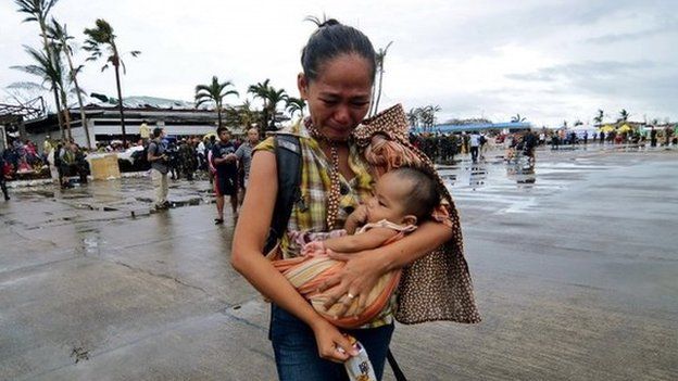 A woman is evacuated from the Philippine island of Leyte after the typhoon, 12 November 2013