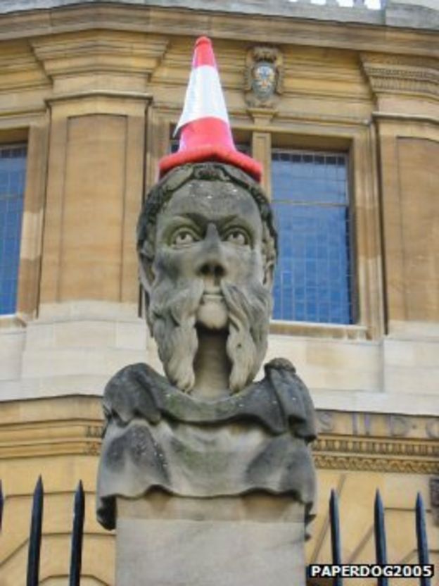 Why do people put traffic cones on statues? - BBC News