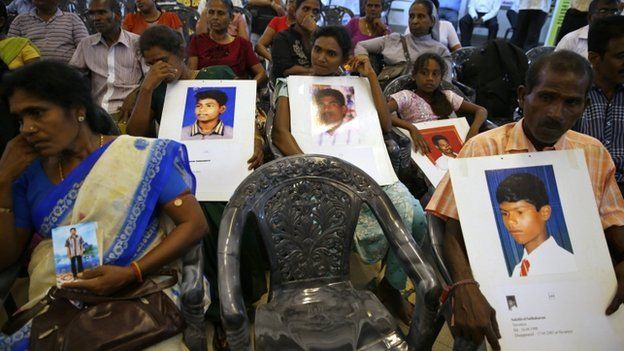 COLOMBO, SRI LANKA - NOVEMBER 13: People belonging to the Sri Lankan minority Tamil ethnic group hold up photos of their relatives who disappeared during the Sri Lankan Civil War