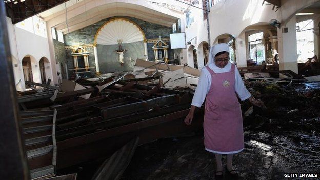 Nun wades through wreckage in St Joseph Church, Tacloban (15 November)
