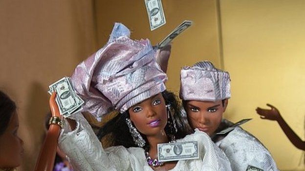 Barbie dolls being sprayed with money at wedding