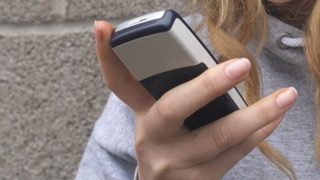 Teenager using phone