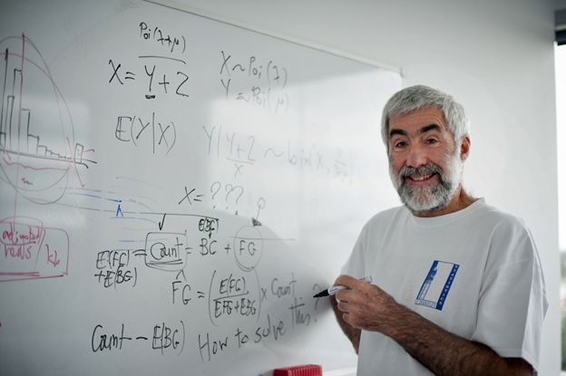 Terry Speed in front of a whiteboard