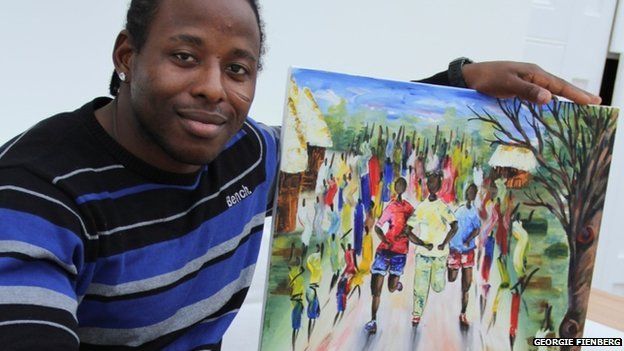 Paul Apowida with a painting