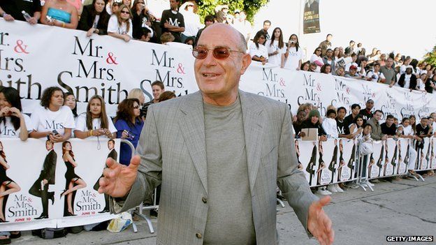 Arnon Milchan standing in front of a crowd