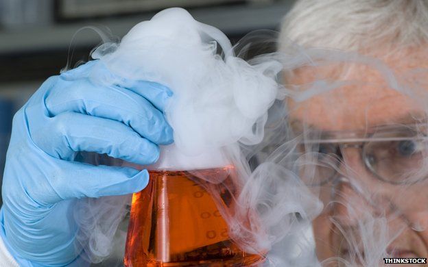 Scientist holds smoking beaker