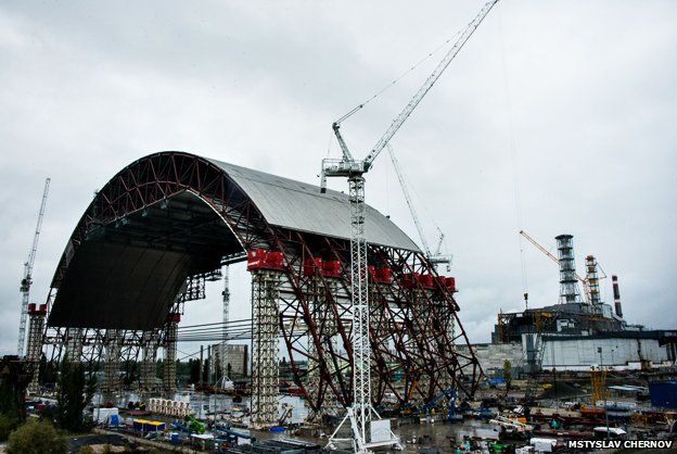 The arch being built at Chernobyl, with the nuclear reactor in the background