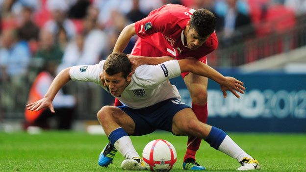 Jack Wilshere tackled by Swiss player