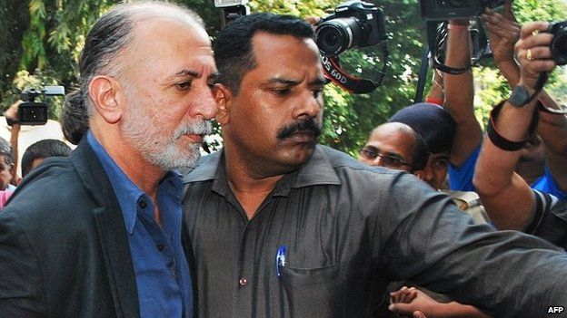 Indian magazine editor, Tarun Tejpal, is escorted by police officials from a courthouse after being remanded in police custody in Panaji on December 1, 2013