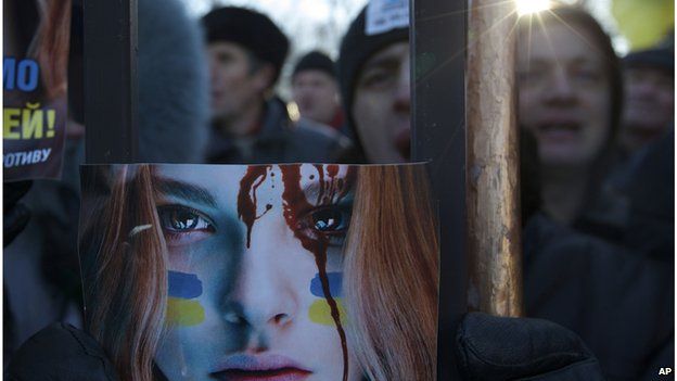 Protestors hold a poster outside the parliament building in Kiev