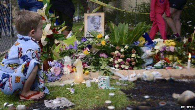 Young white boy pays tribute outside Mr Mandela's house in Johannesburg