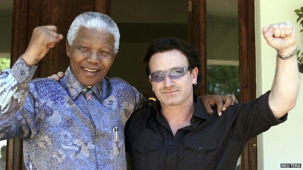 Former South African President Nelson Mandela (left) and Irish rock star Bono pose together after meeting at in Johannesburg on 25 May, 2002