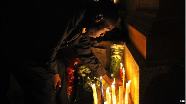 A man lights a candle outside the Union Buildings in Pretoria