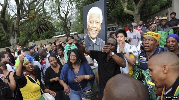 Mourners gather outside former President Nelson Mandela"s house in Houghton, Johannesburg, on 6 December, 2013