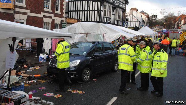 Car amongst market stalls in Mold