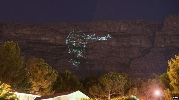 A lighting installation showing a face of Nelson Mandela, shines on Table Mountain, to commemorate the life of late former South Africa President Nelson Mandela