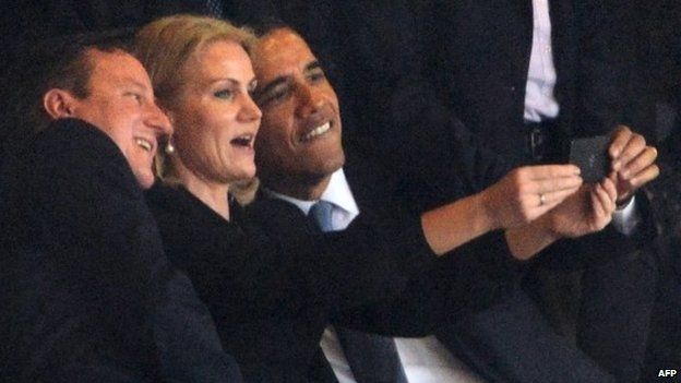 The US President Barack Obama and British Prime Minister David Cameron pose for a 'selfie' picture taken by Denmark's Prime Minister Helle Thorning Schmidt during the memorial service for Nelson Mandela at the FNB Stadium in Johannesburg.