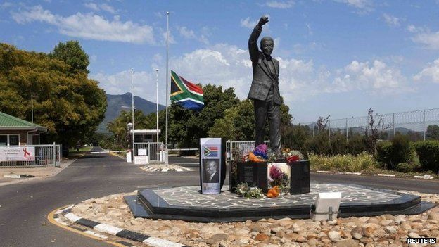 Wreaths of flowers and personal messages are left at the Mandela statue at the entrance of the Groot Drakenstein Prison, formerly Victor Verster Prison