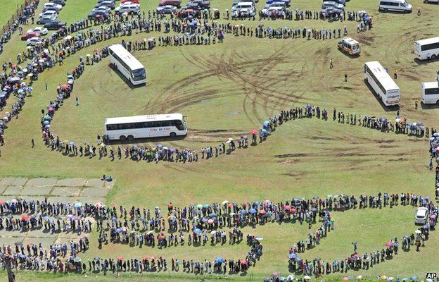 People queue for busses before heading to the Union Buildings in Pretoria, South Africa