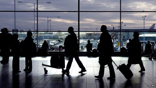 Passengers walking through an airport