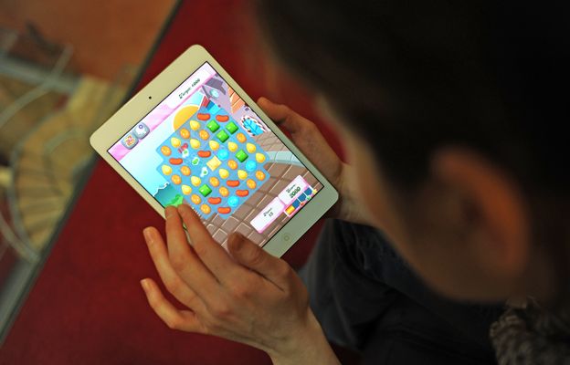 Woman plays Candy Crush Saga on iPad