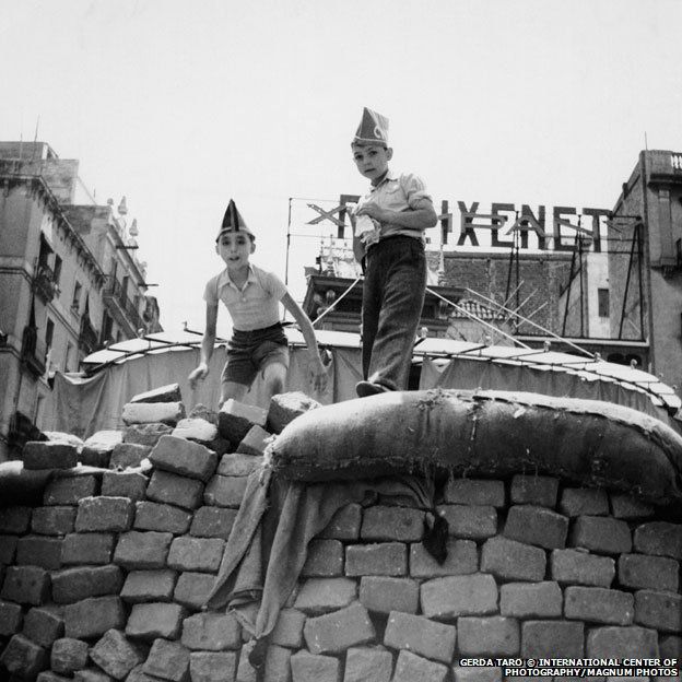 Two boys standing on the barricades