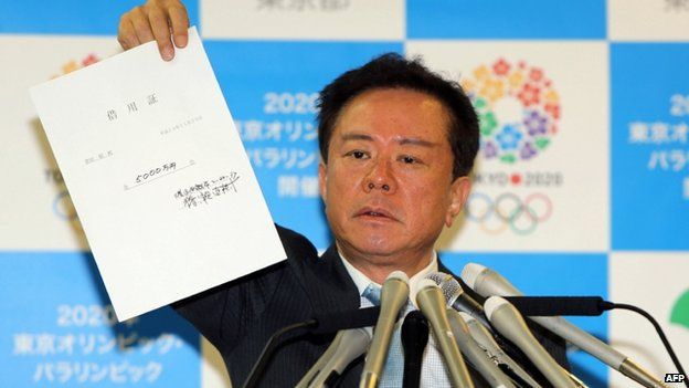 File photo: Tokyo Governor Naoki Inose shows the $500,000 IOU during a press conference at the Tokyo metropolitan government office on 26 November 2013